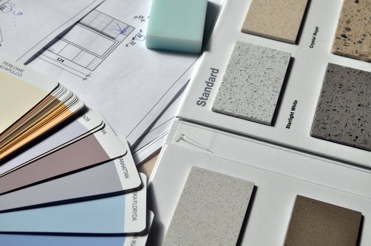 why-choose-us Color palette and material samples for interior renovation projects on a blueprint.
